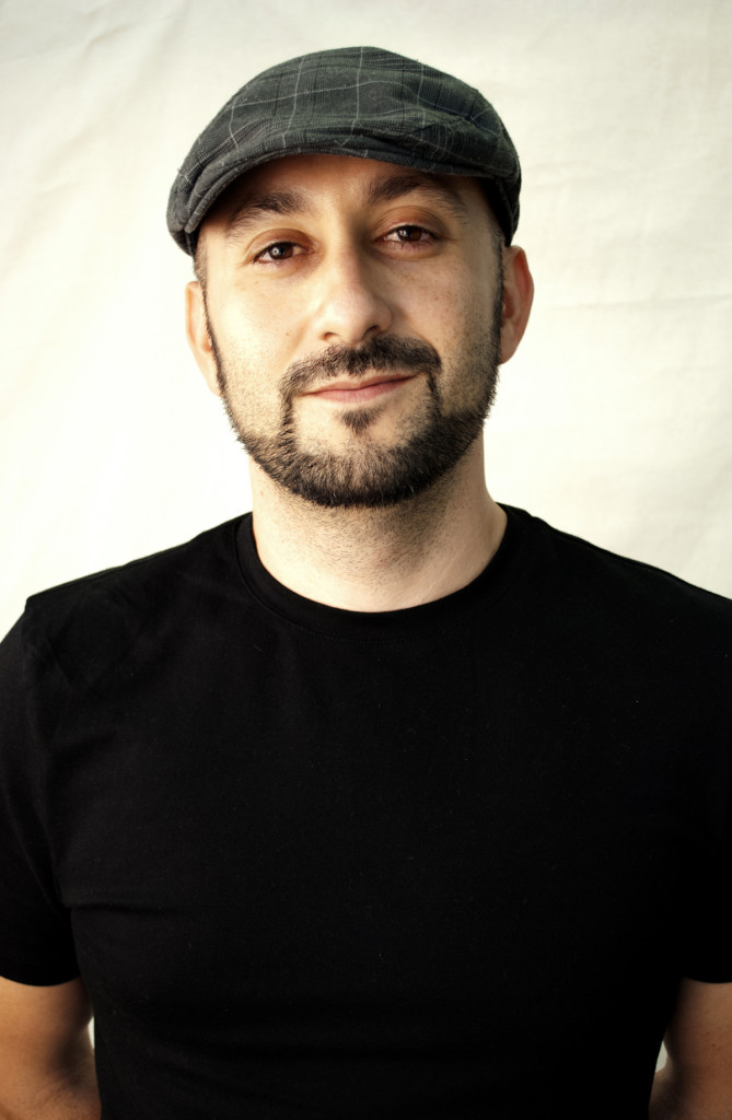 Man in a black t-shirt and hat.